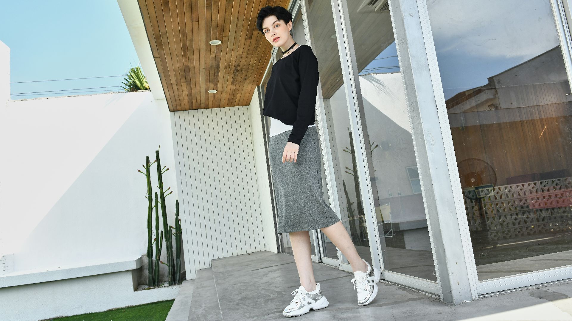 a woman is standing outside of a house