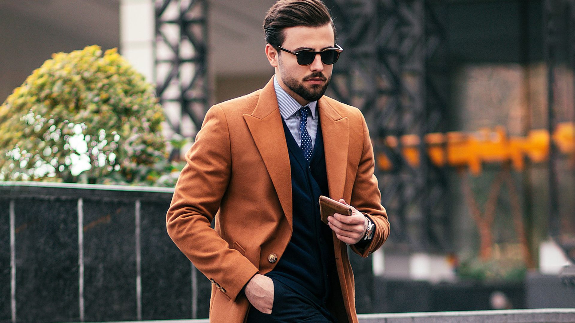 a man in a suit and tie walking down some steps