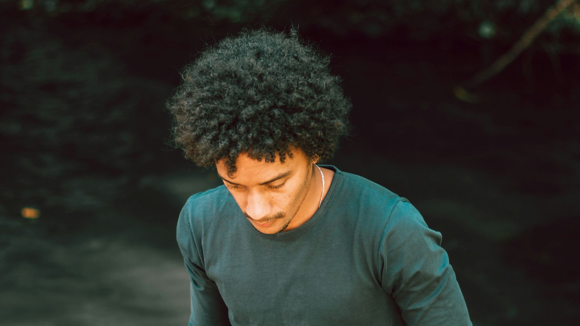 man in black long sleeve shirt standing near body of water during daytime