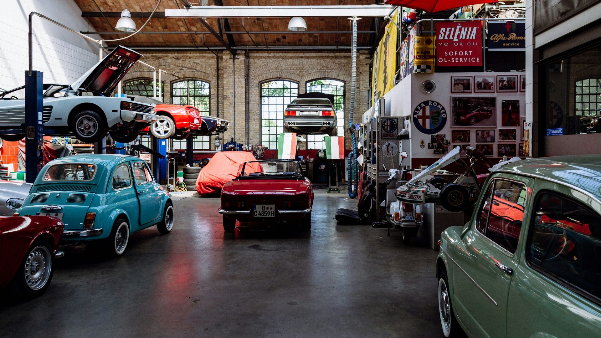 several vehicles parked beside wall