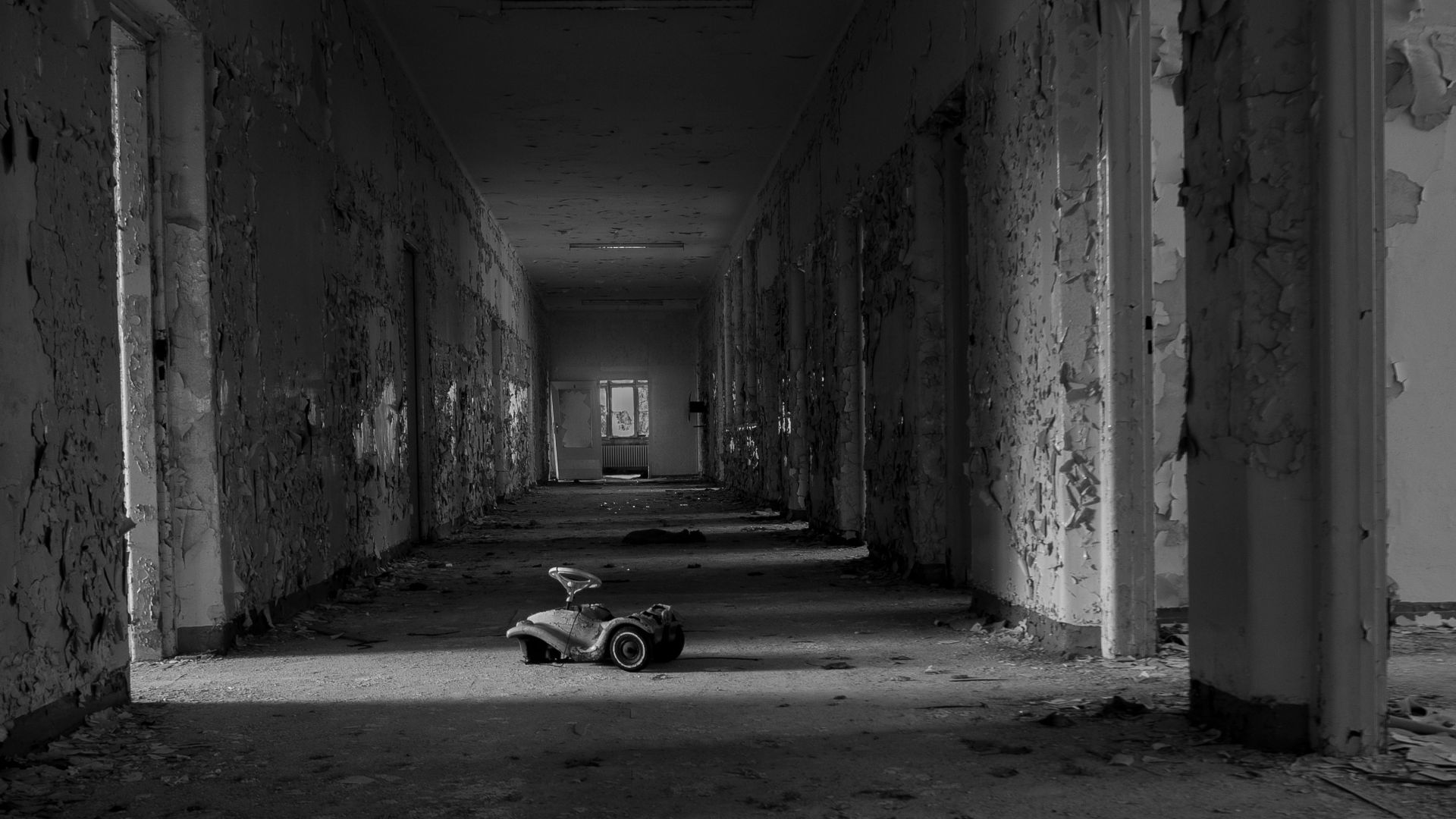 grayscale photo of car parked in tunnel