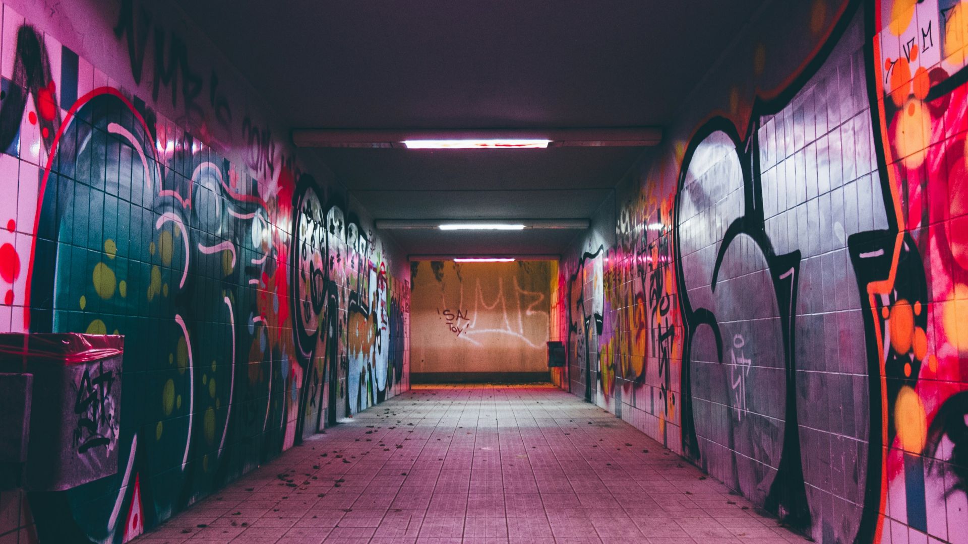 empty tunnel pathway with graffiti walls