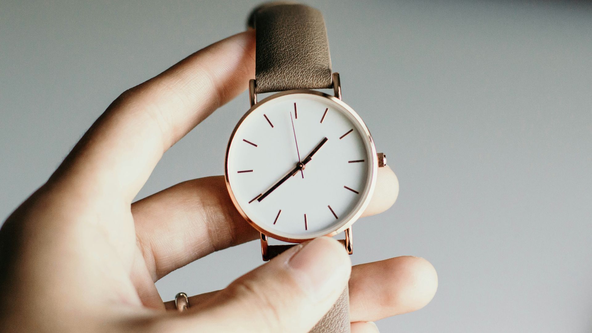 person holding analog watch