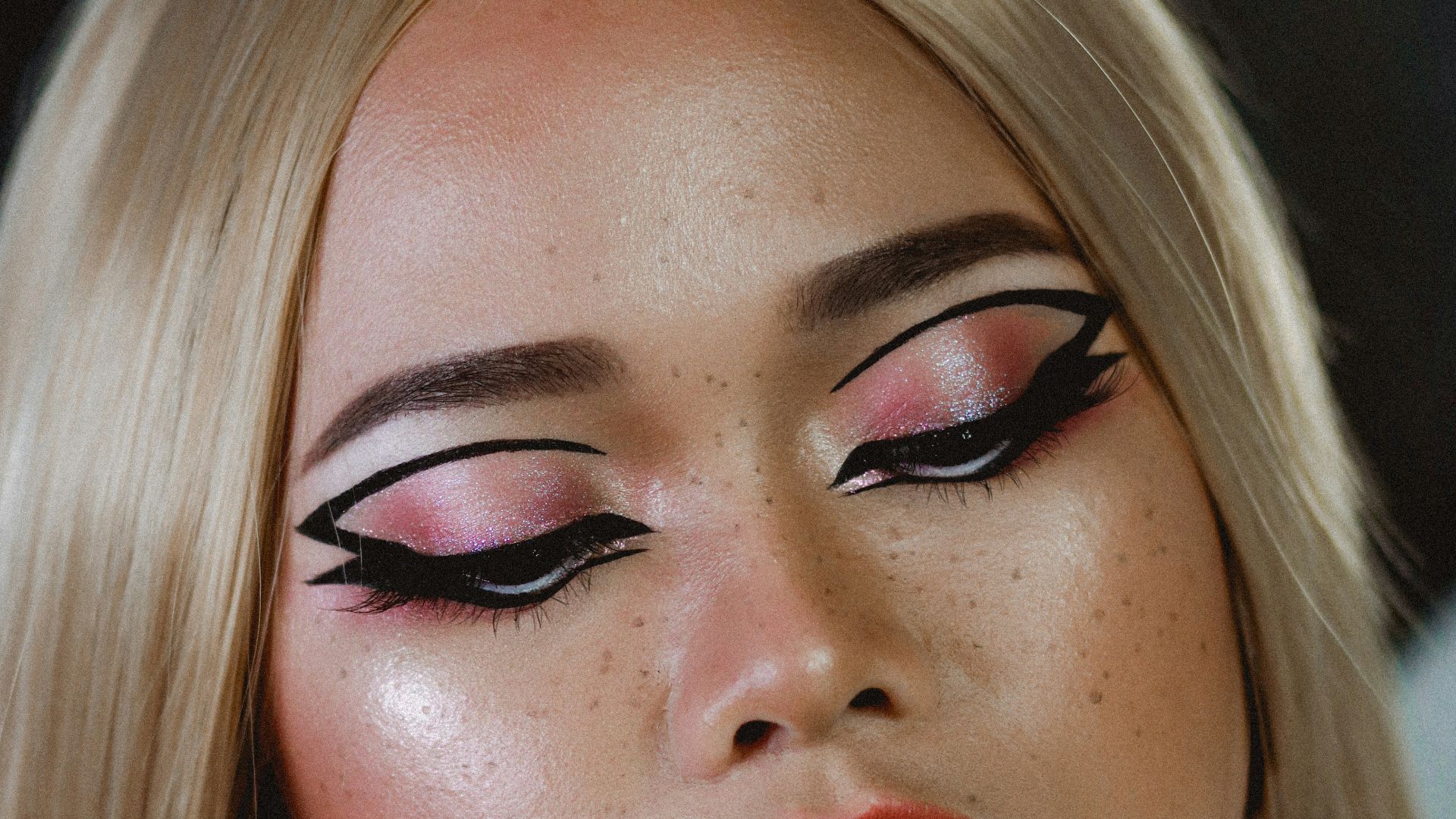 a woman with long blonde hair and red lipstick