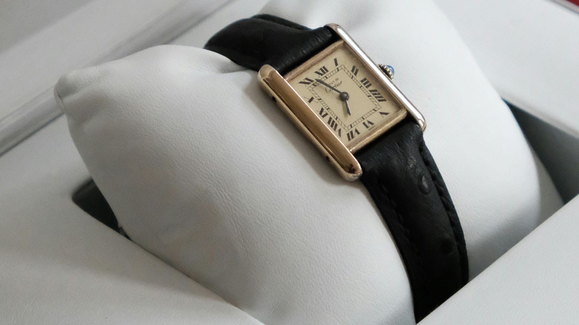 gold and black analog watch in box