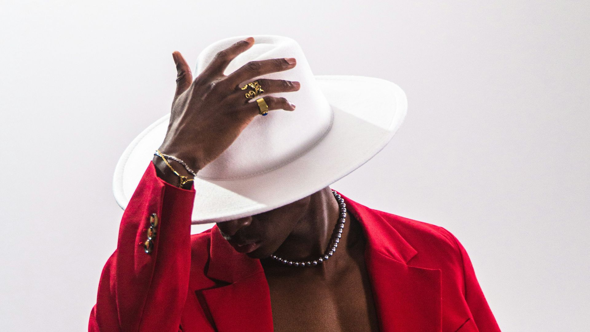 a person wearing a red coat and white hat