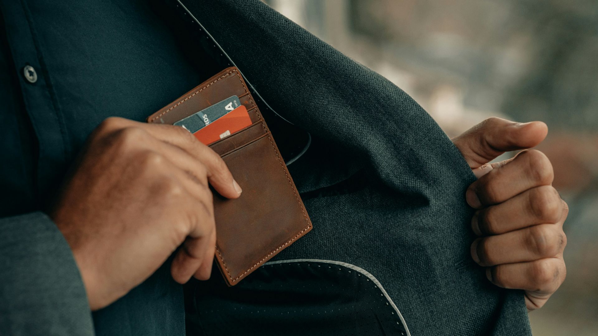 a man holding a wallet in his pocket