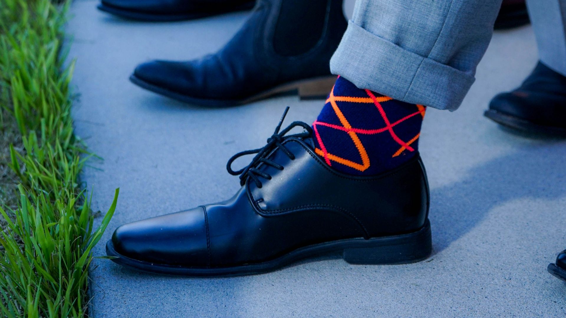 people showing black leather dress shoe lot outdoor during daytime