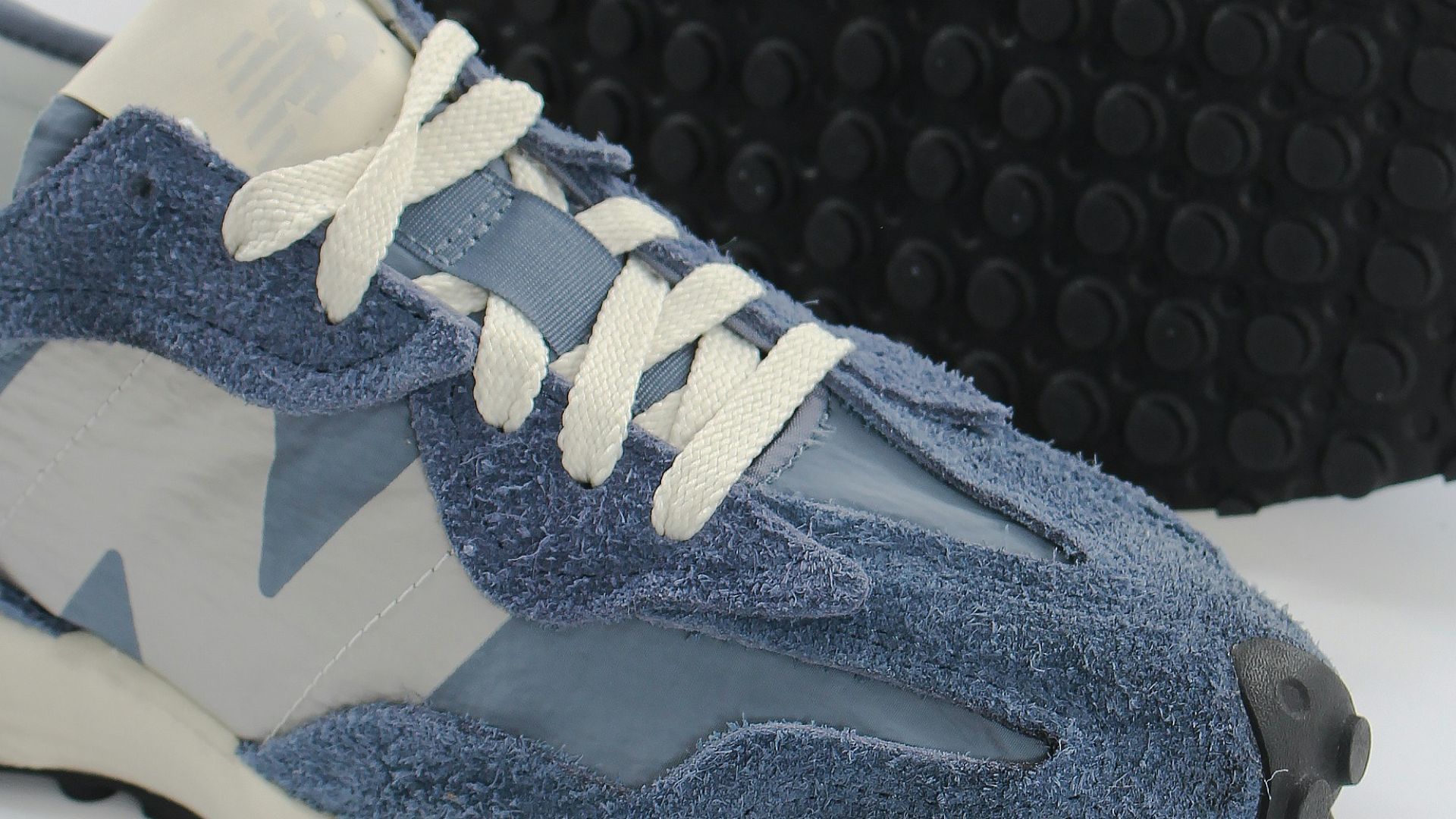 a pair of blue and white sneakers on a white background