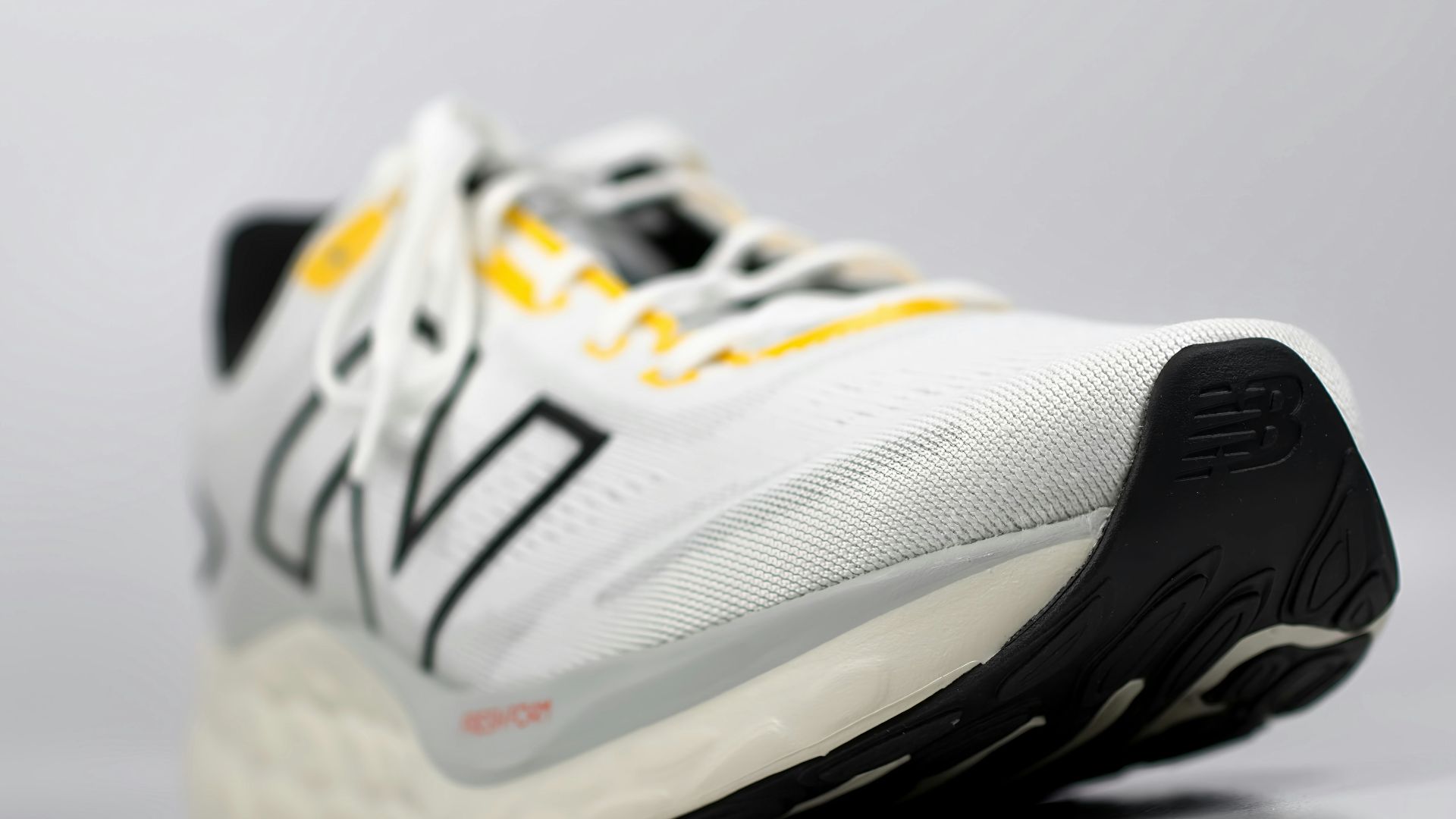 a close up of a white and yellow shoe