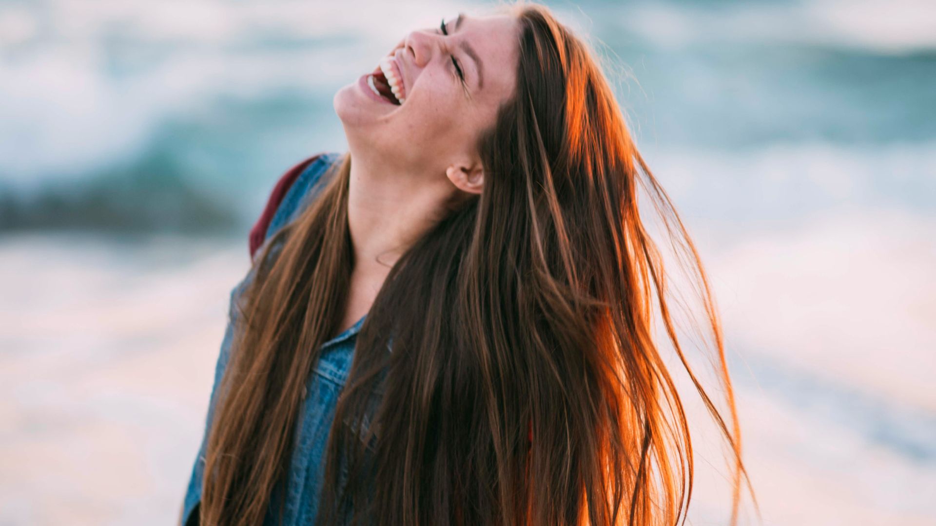 woman in blue denim top taking a photo