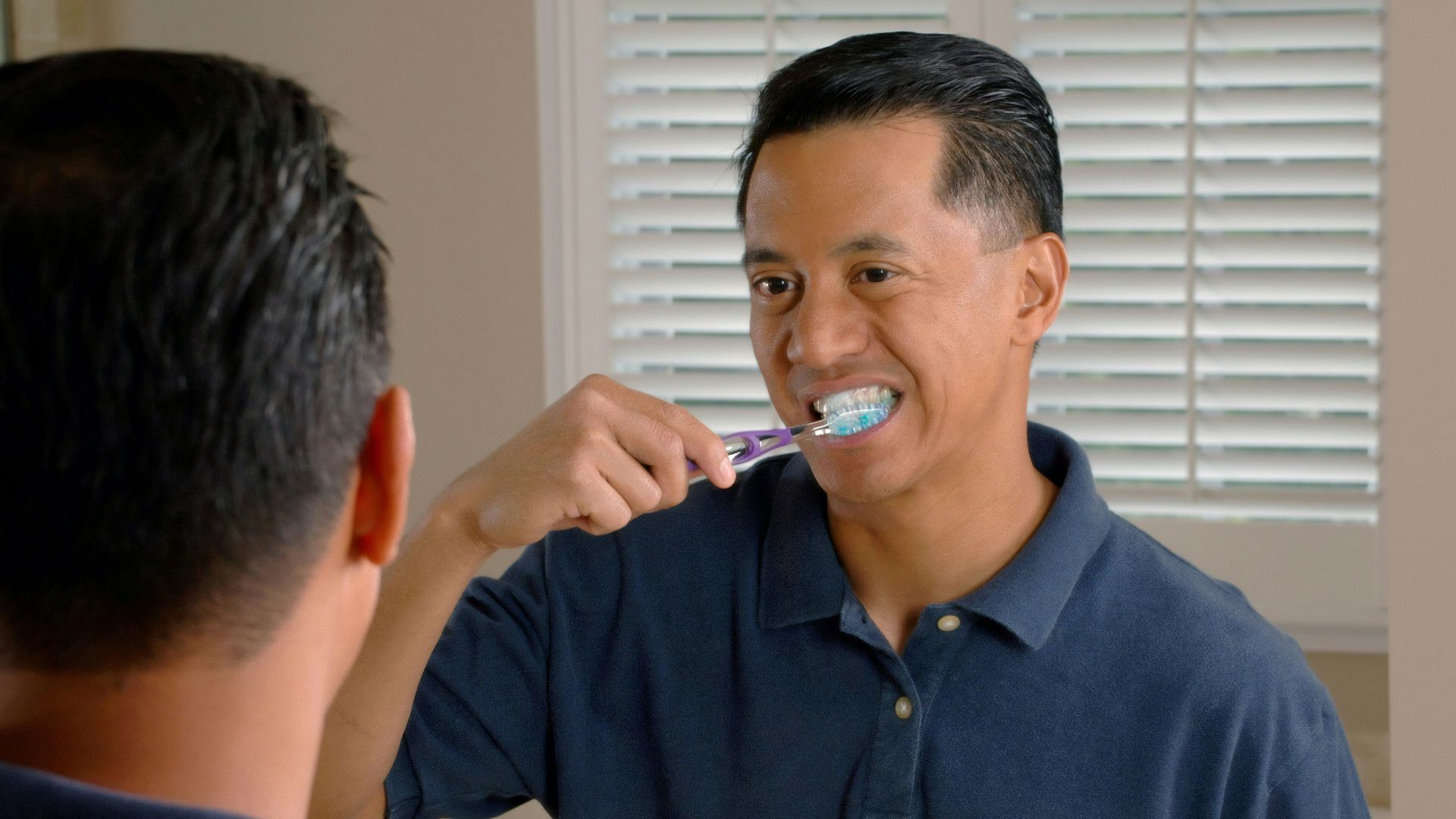 man in blue polo shirt smoking cigarette