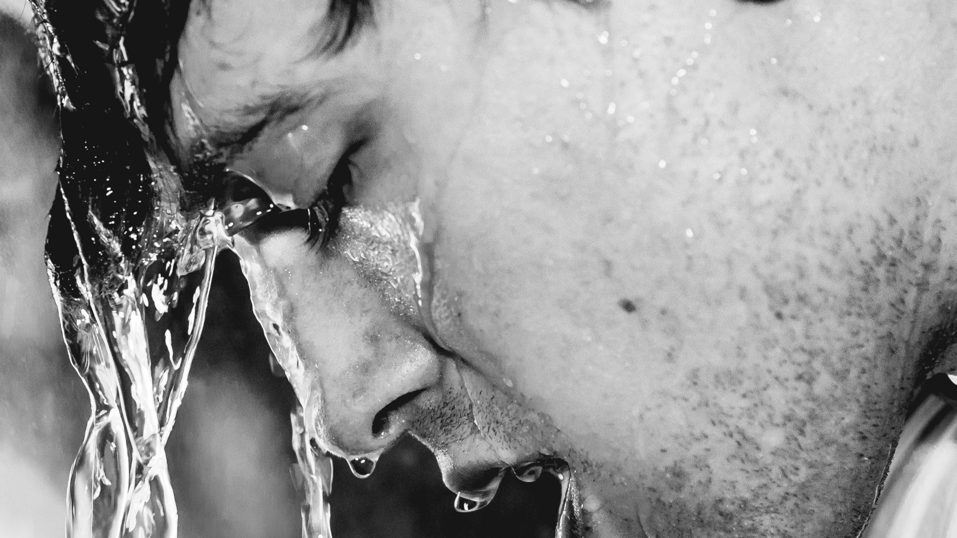 man in white shirt with water droplets