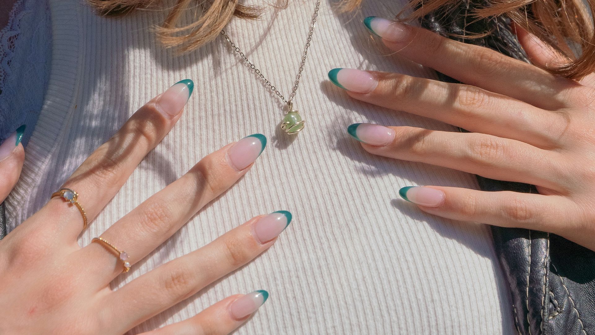 a close up of a woman with her hands on her chest