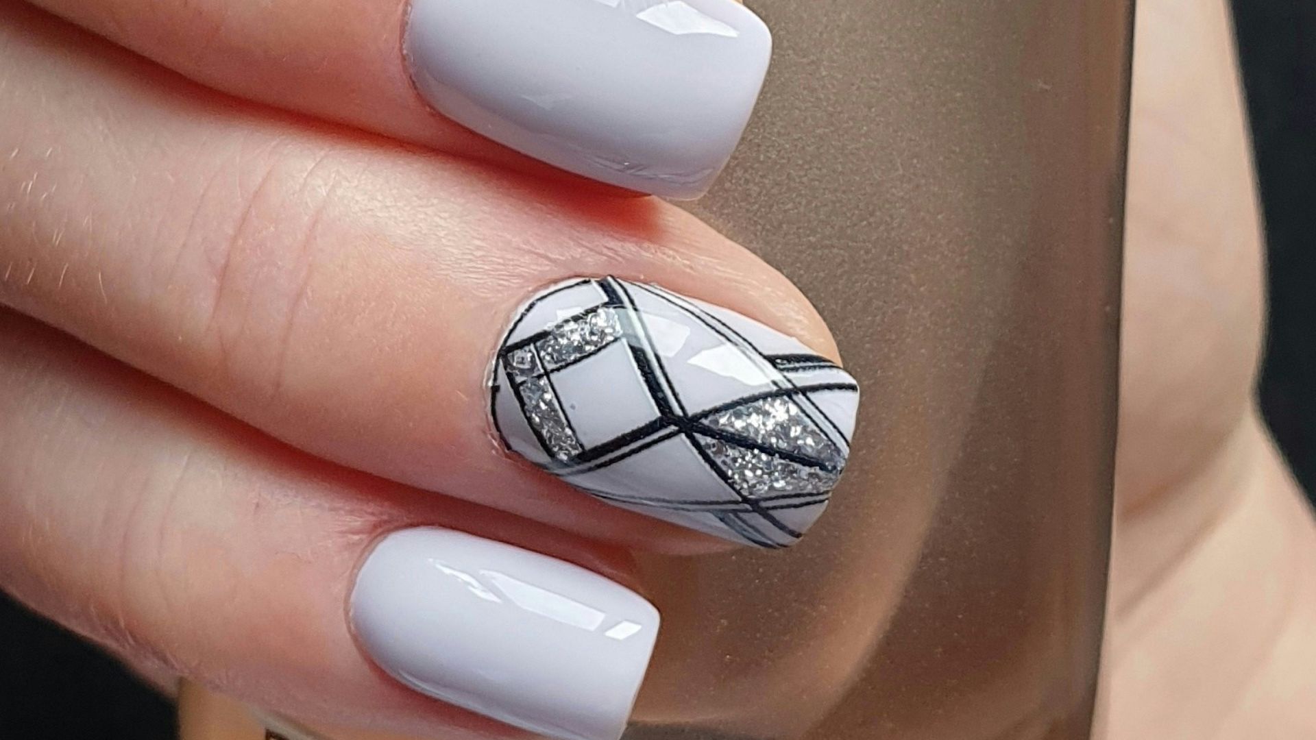 person holding silver and black bottle