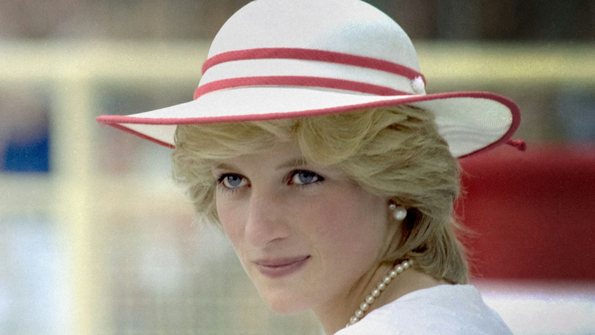 a woman in a red and white dress and hat