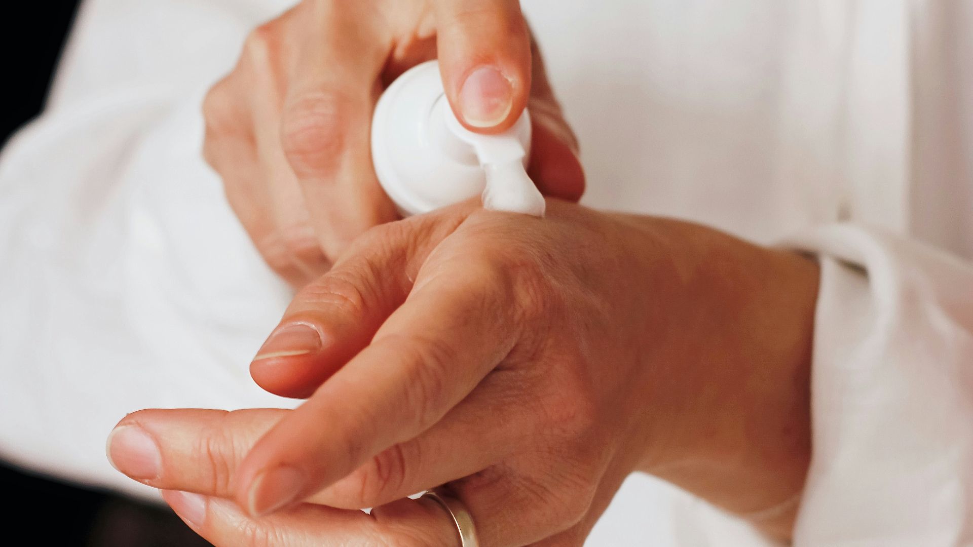 person holding white round ornament