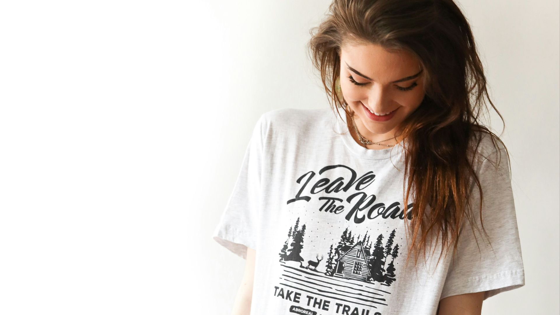 smiling woman in black and white print t-shirt