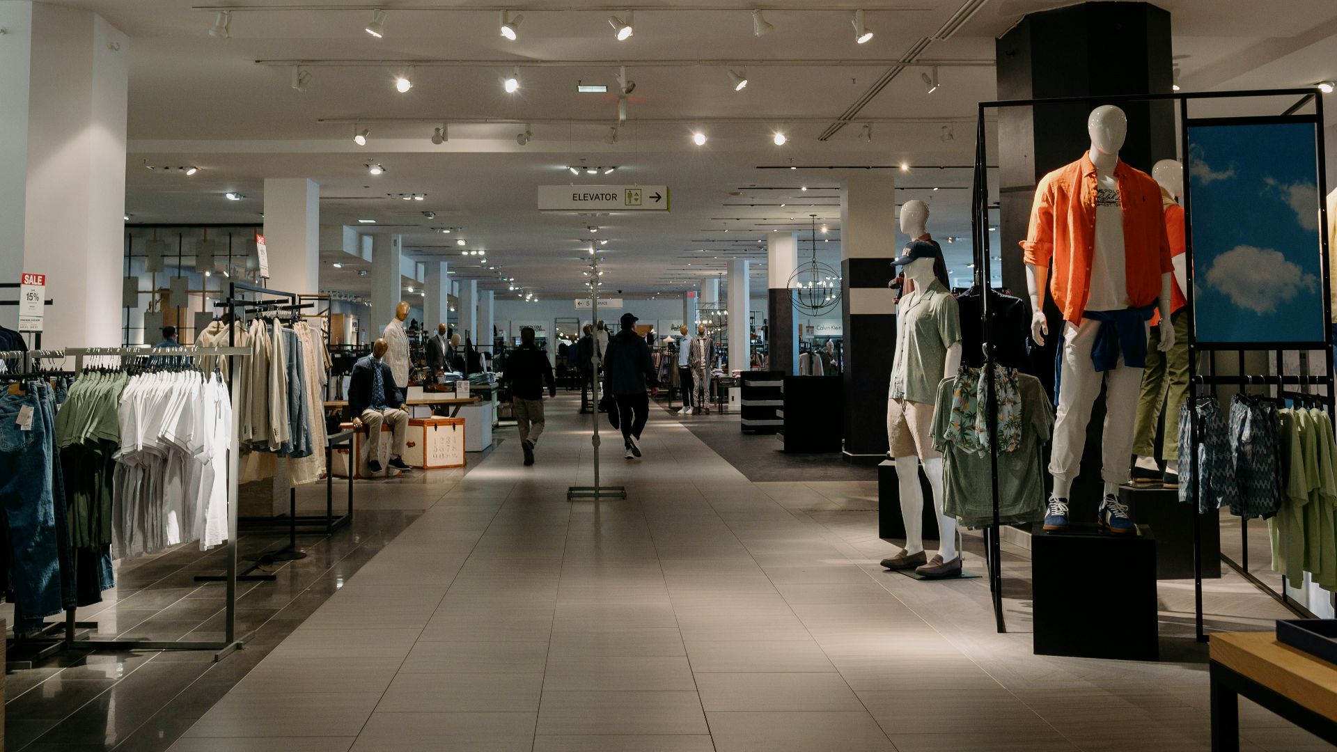 Inside of a department store with clothes on display.