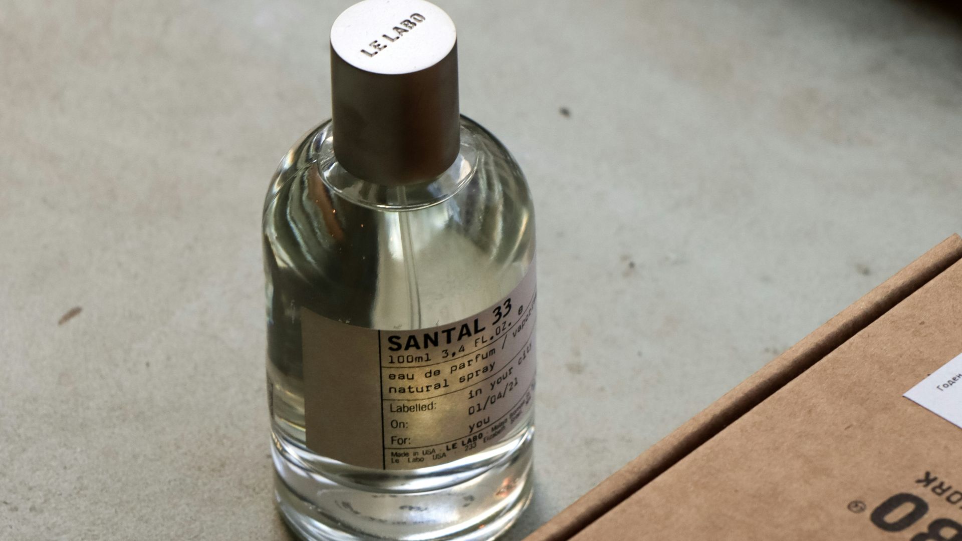 a bottle of cologne sitting next to a box