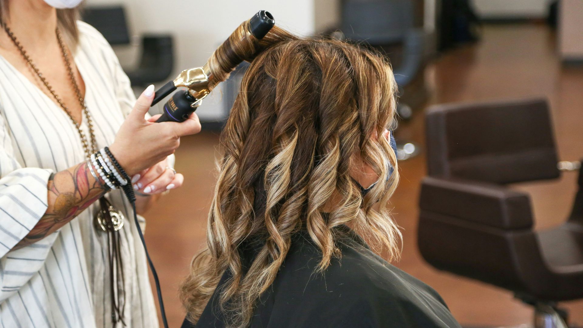 woman in black long sleeve shirt holding black smartphone