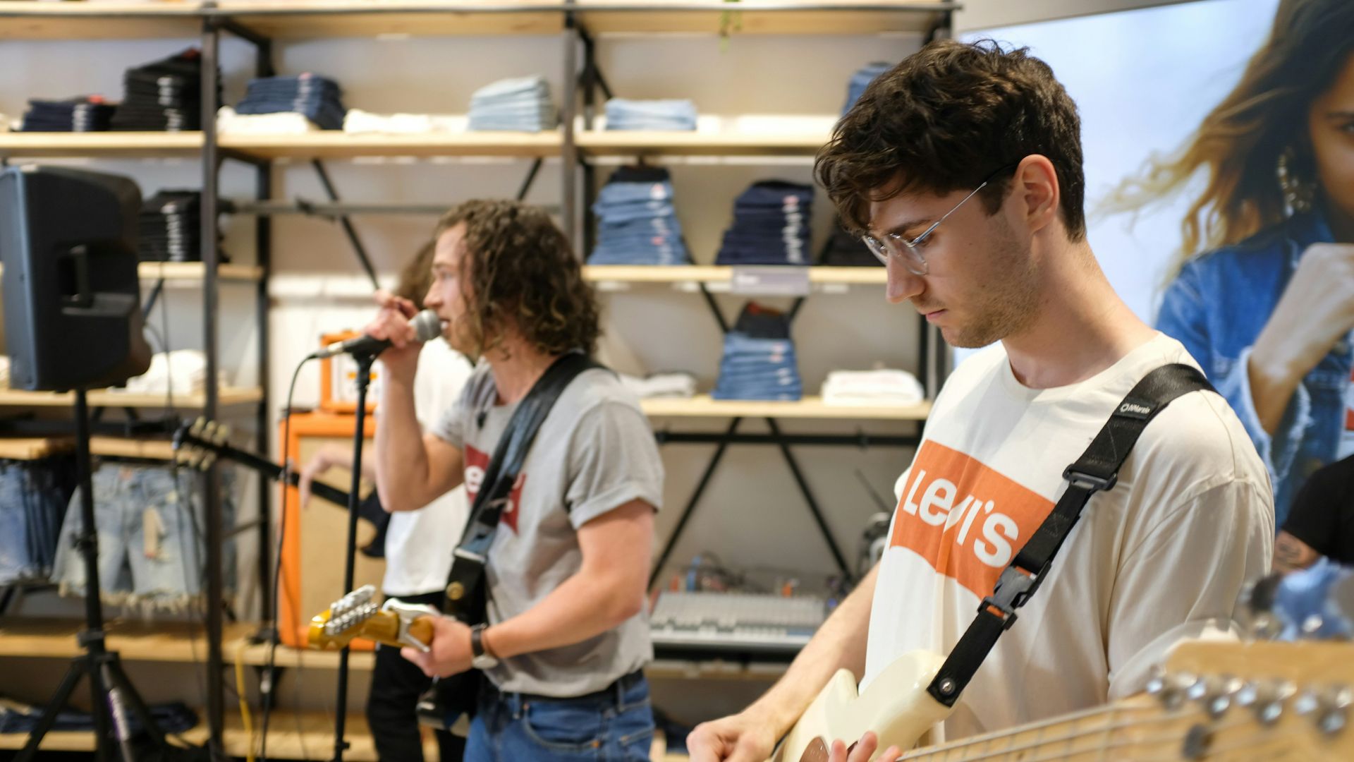 a man playing a bass guitar in a store