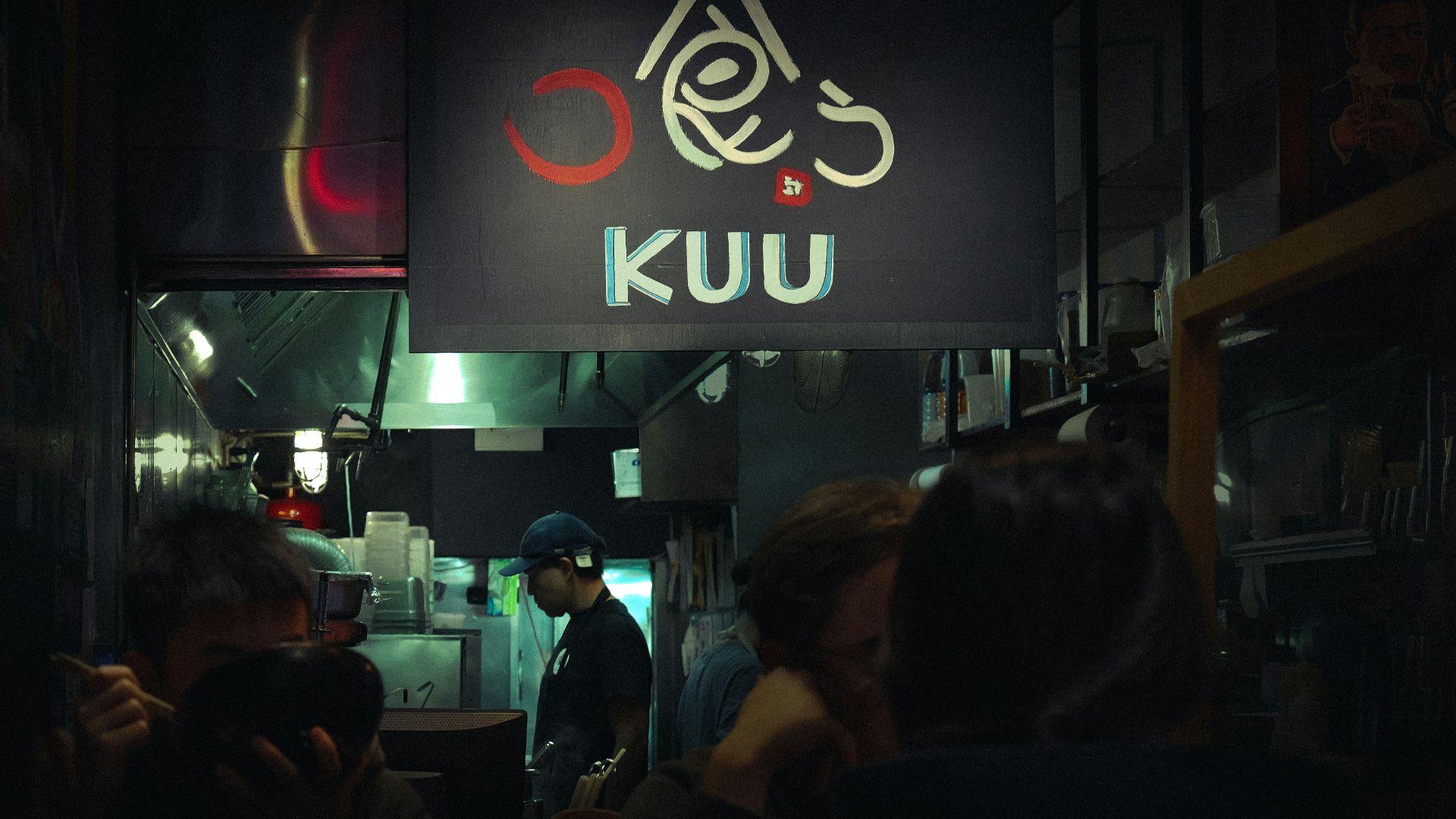 a group of people standing in front of a restaurant