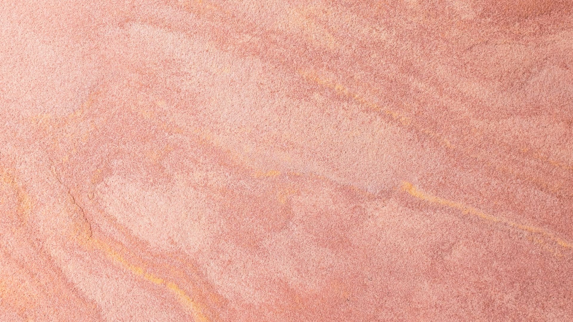 a skateboarder is riding on a pink surface