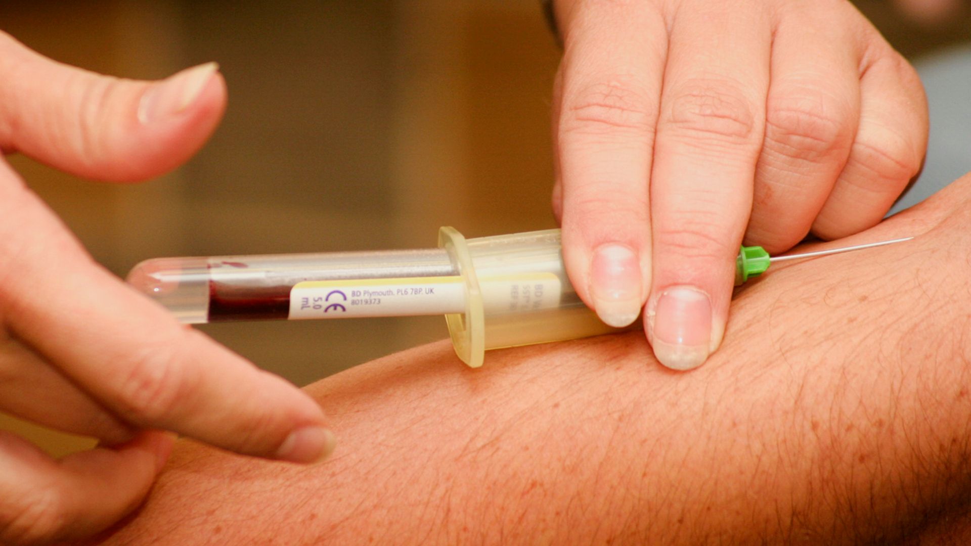 person injecting syringe