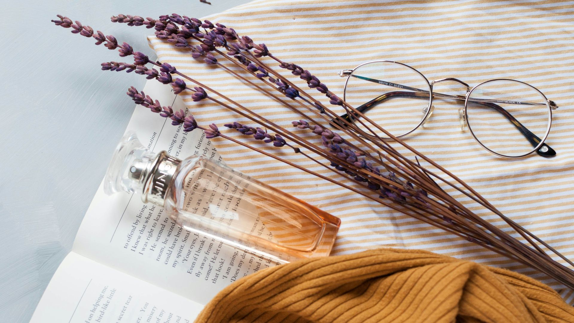 fragrance bottle, lavender, and eyeglasses