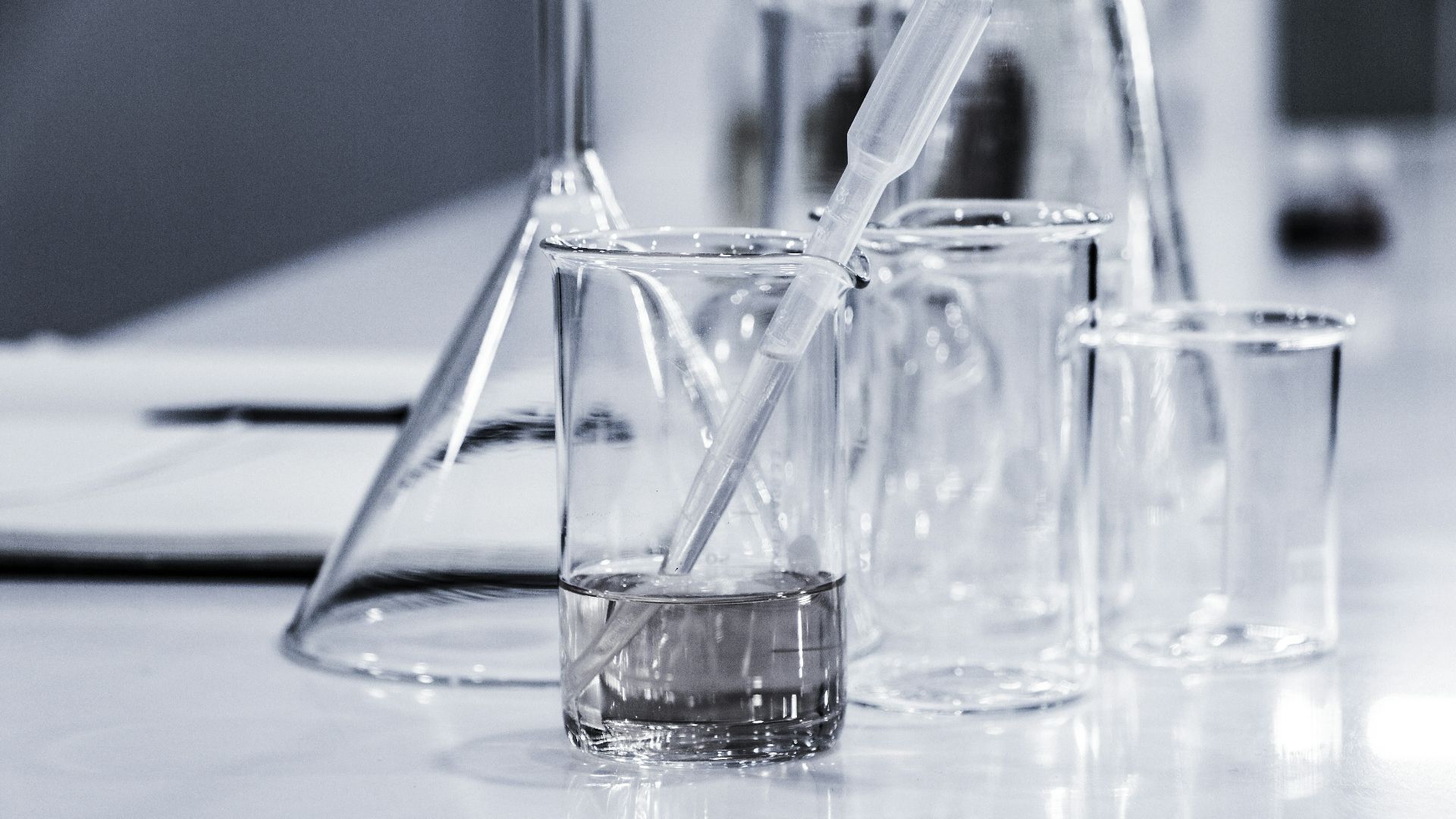 three clear beakers placed on tabletop