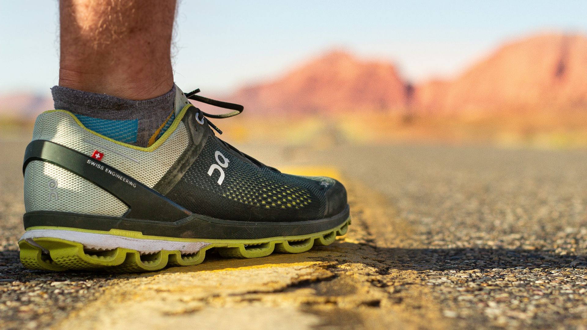 person wearing black and yellow nike running shoes