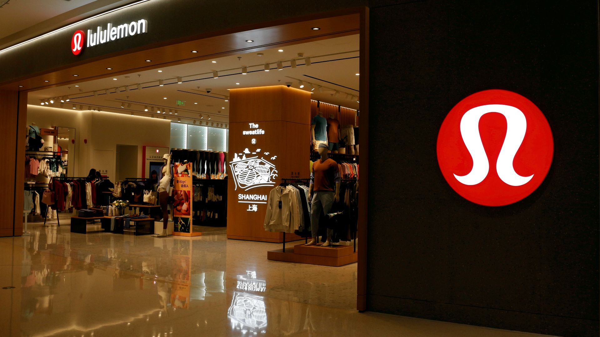 a shopping mall with a sign that says the store is open