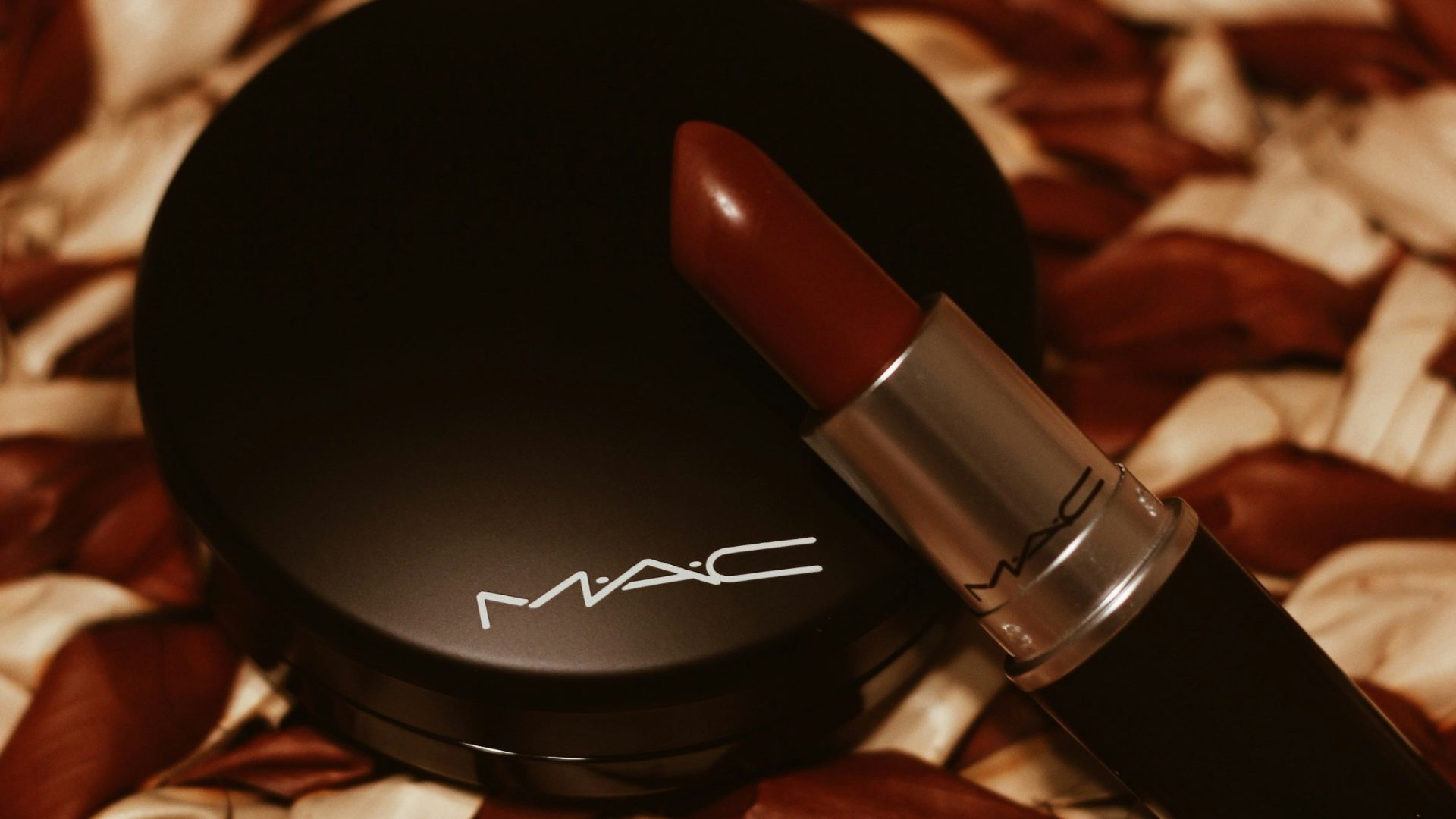 red lipstick on brown and white textile