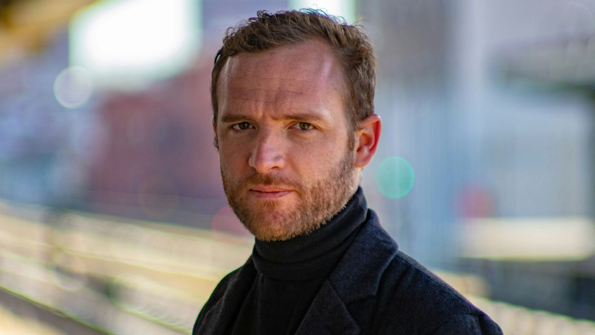 man wearing black notched lapel suit jacket