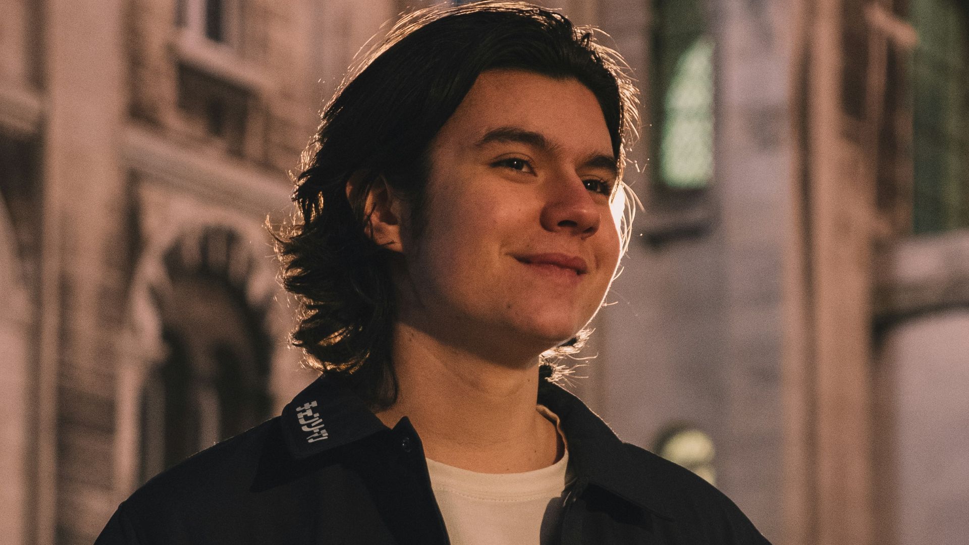 a man standing in front of a large building