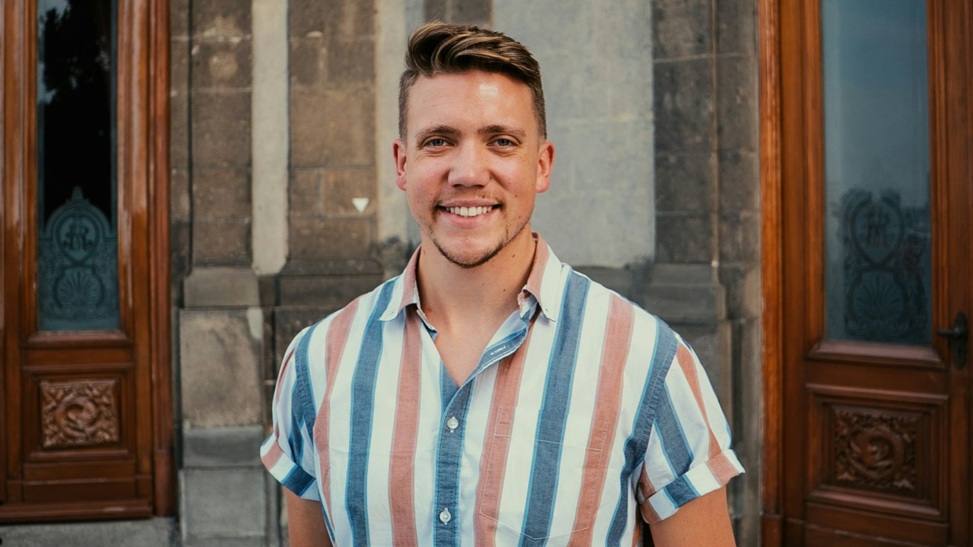 a man standing in front of a checkered floor