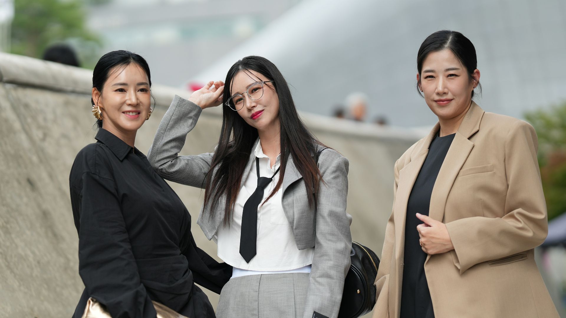 A group of three women standing next to each other