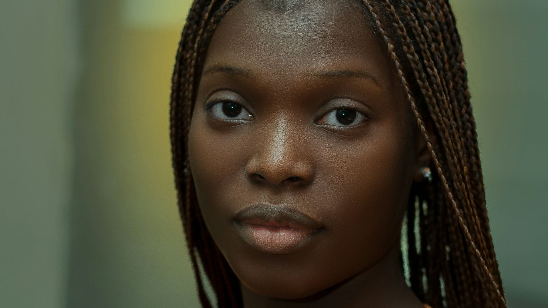 a woman with braids standing in a room