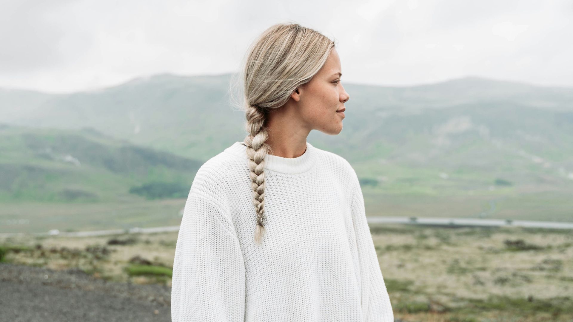 woman standing and looking mountain at daytime