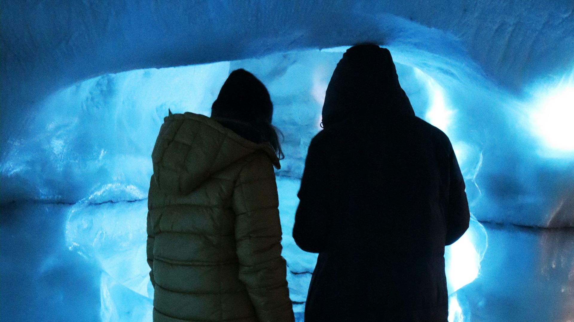 a couple of people that are standing in a tunnel
