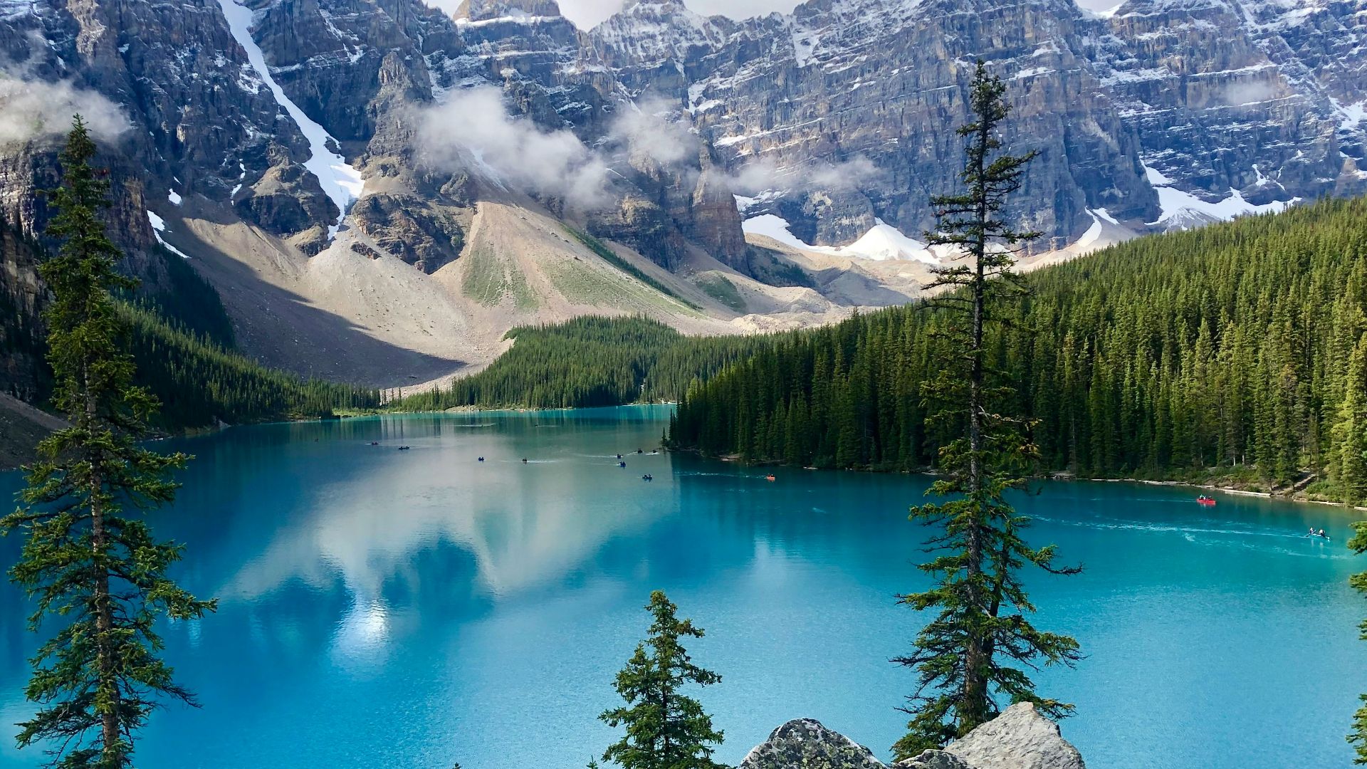 a blue lake surrounded by mountains and trees