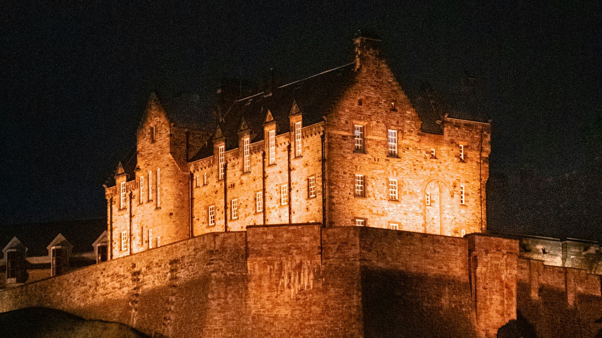 A lit-up castle stands proudly at night.