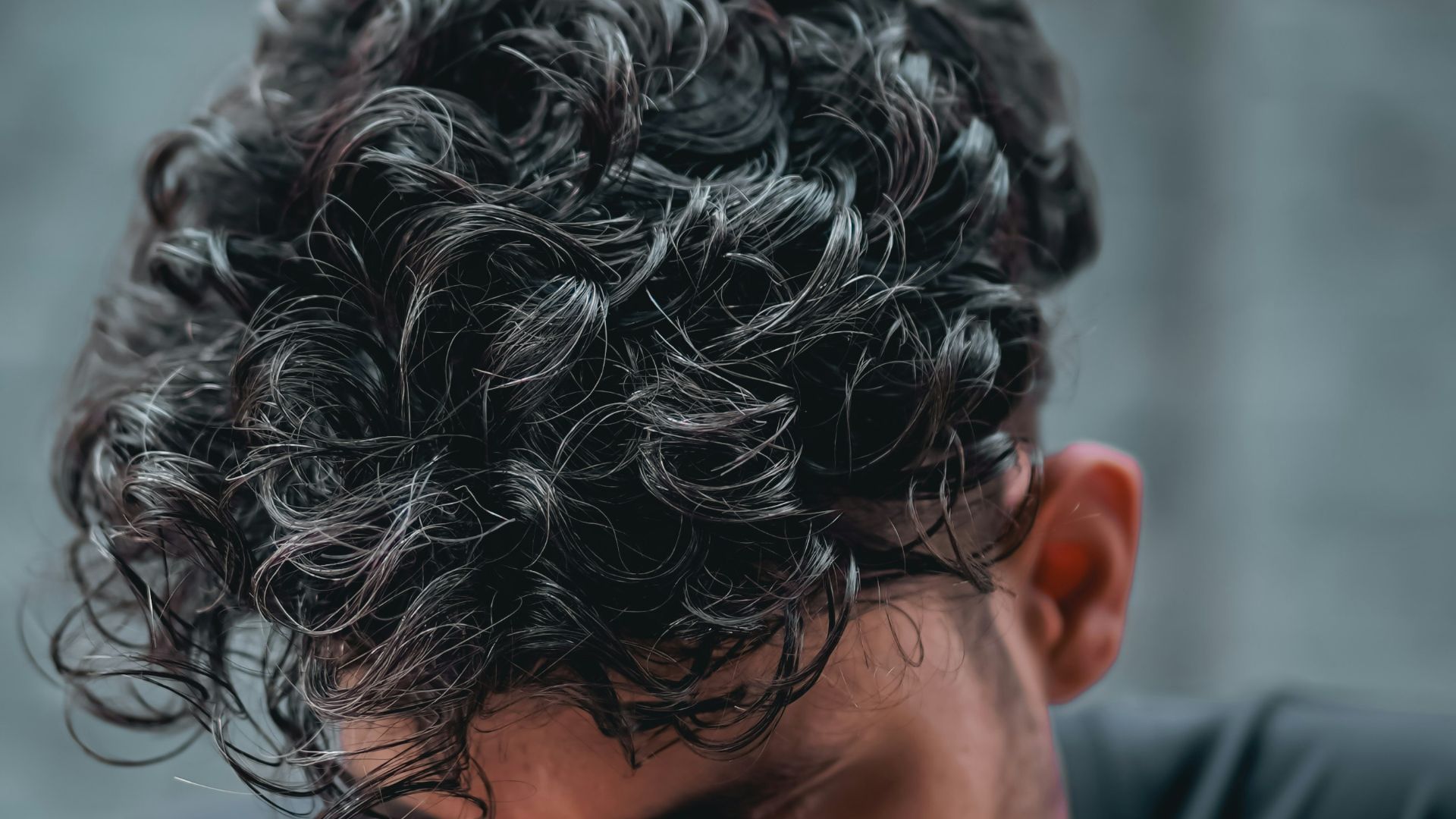 a close up of a person with curly hair
