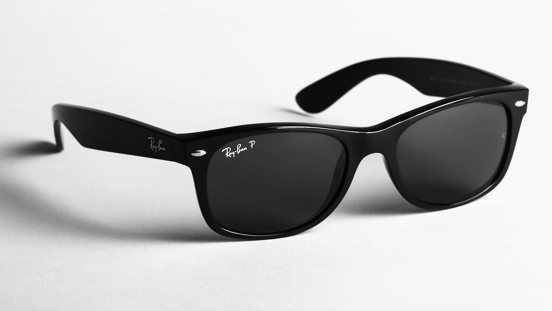 shallow focus photo of black Ray-Ban wayfarer sunglasses
