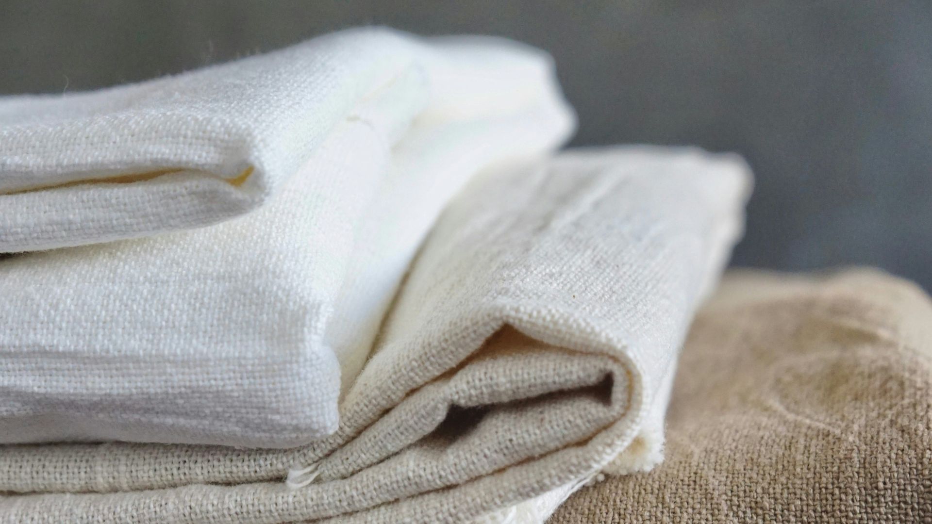 white textile on brown wooden table