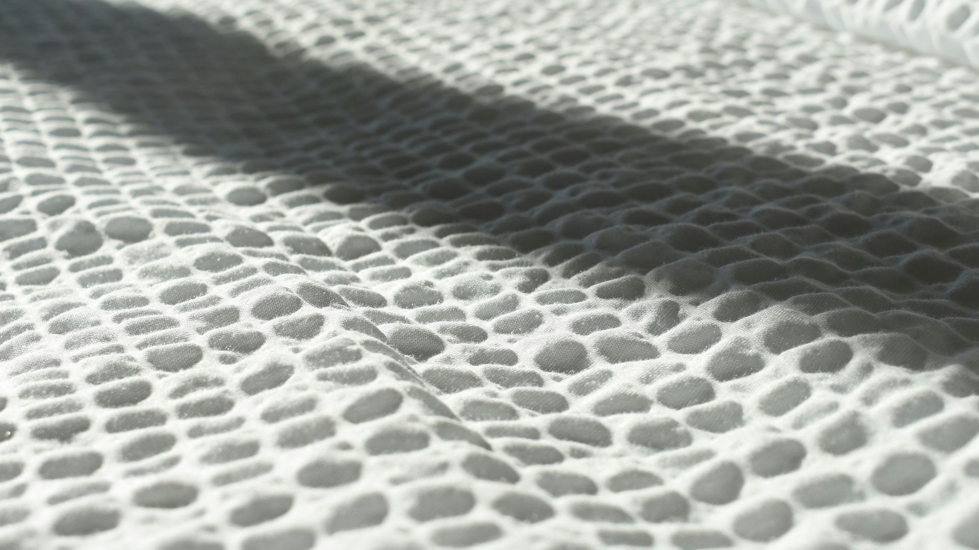 The shadow of a person on a snowboard