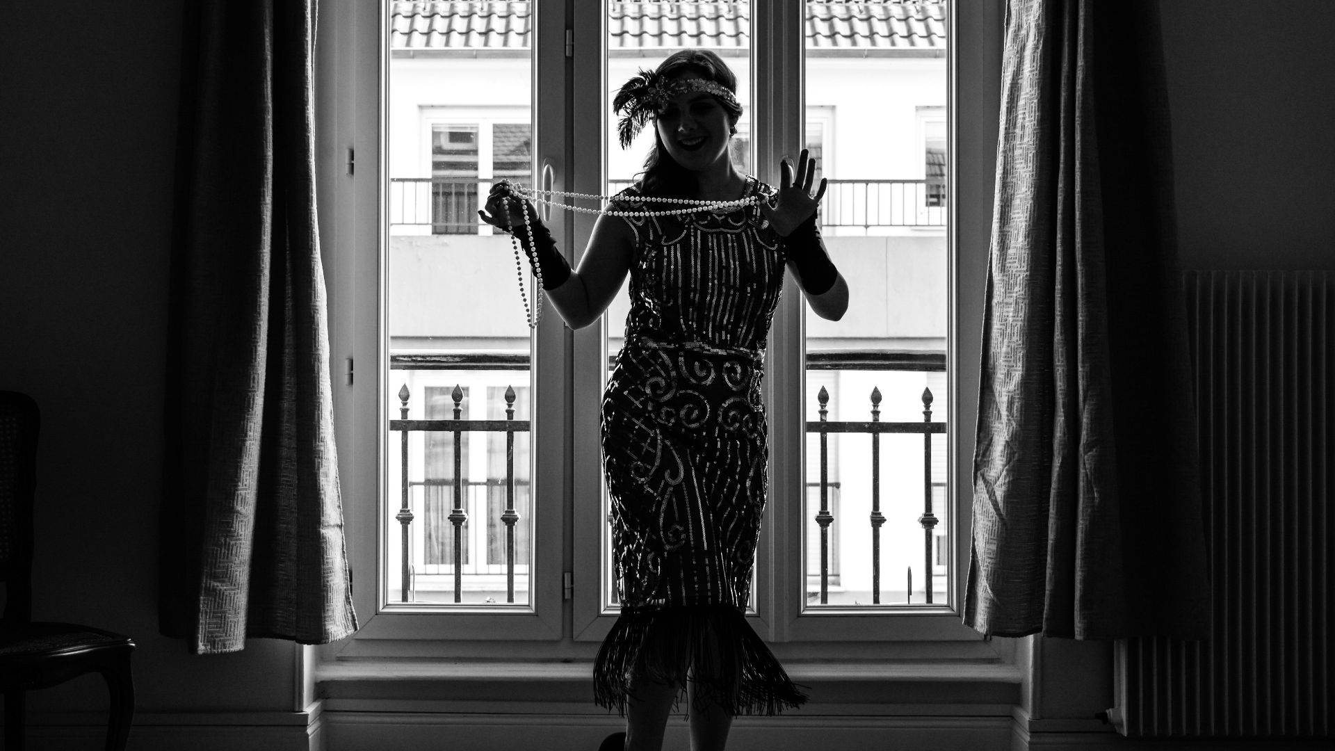 a person in a dress dancing in a room with a large window
