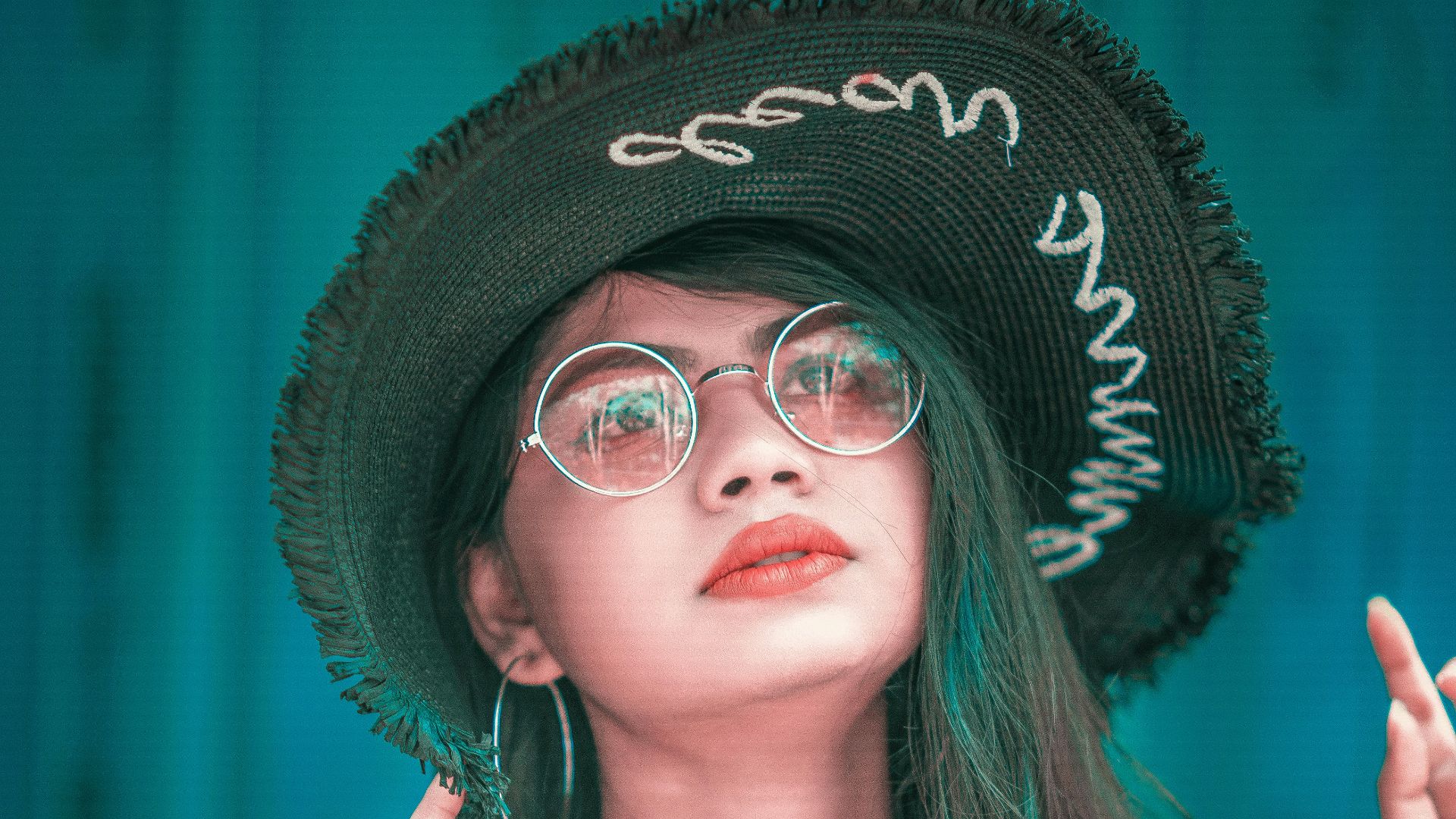 selective focus photography of woman wearing floral dress and black hat