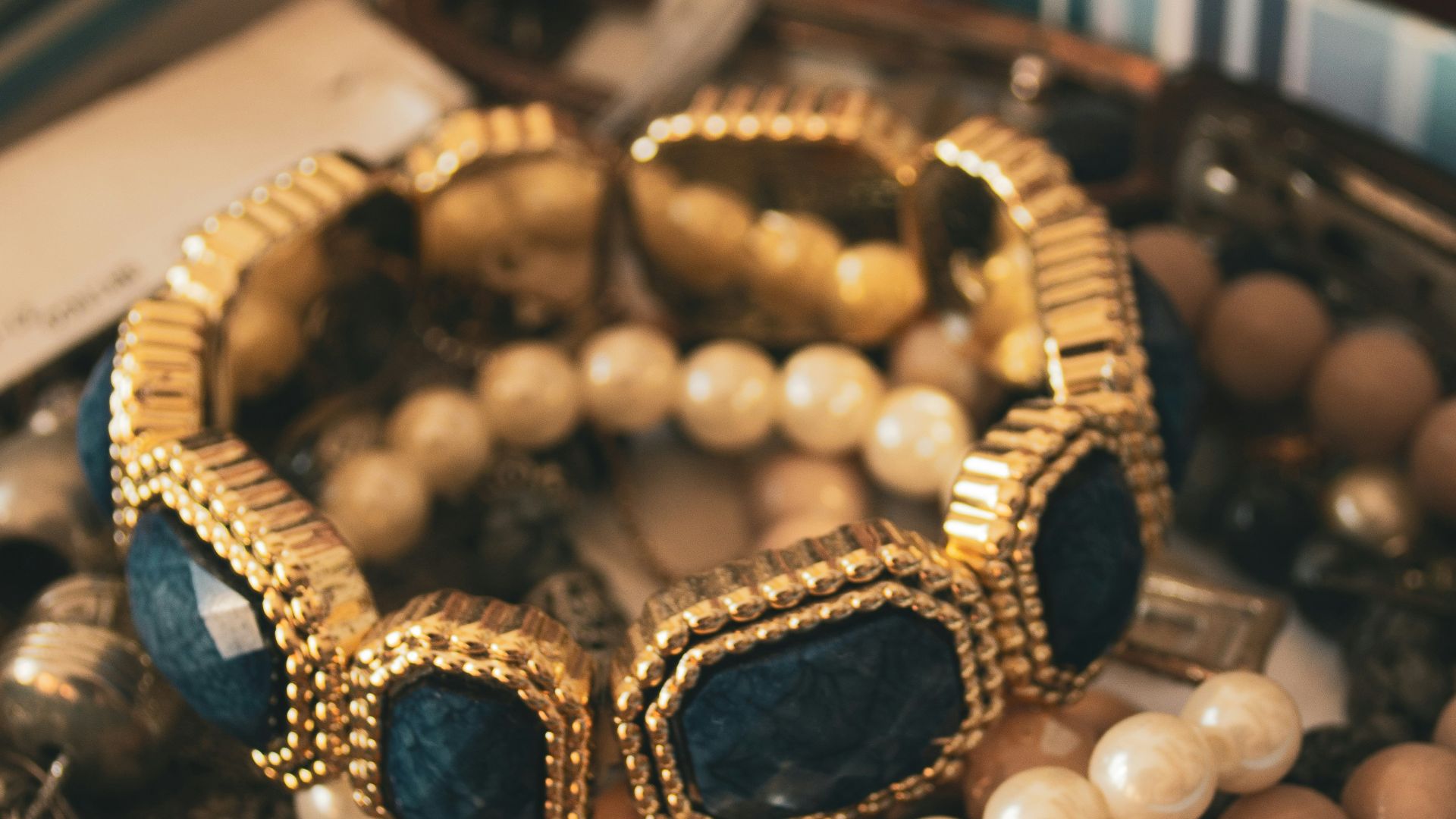 a box filled with lots of jewelry on top of a table